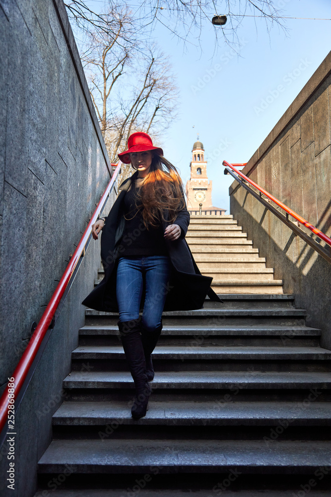 Girl descends and enters the Cairoli Metro Station in Milan Italy Girl descends and enters the Cairoli Metro Station in Milan Italy