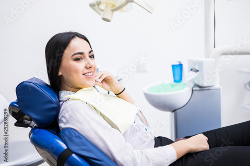 Overview of dental caries prevention. Woman at the dentist's chair during a dental procedure. Beautiful Woman smile close up. Healthy Smile. Beautiful Female Smile photo