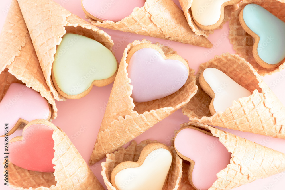 Valentine's day background. Ice cream waffle cone with ginger cookie in shape heart on pink background. Valentine day concept, design. Flat lay, top view Valentine's day background. Ice cream waffle cone with ginger cookie in shape heart on pink background. Valentine day concept, design. Flat lay, top view