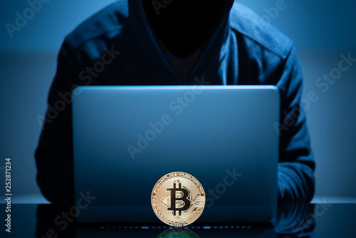 Hacker try to hack bitcoin blockchain system with laptop in dark room