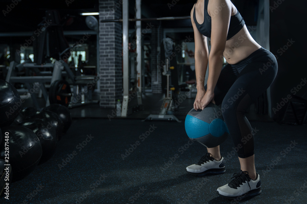 Woman exercise workout at gym fitness training sport with kettlebells weight lifting and legs squat healthy lifestyle bodybuilding. Weightlifting, Fitness concept Woman exercise workout at gym fitness training sport with kettlebells weight lifting and legs squat healthy lifestyle bodybuilding. Weightlifting, Fitness concept