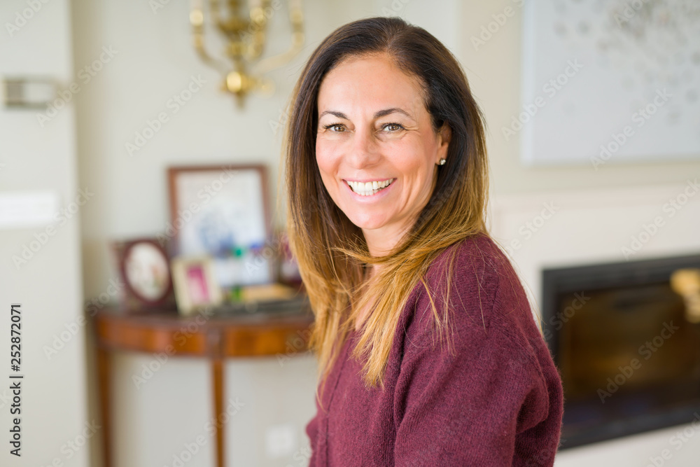 Beautiful middle age woman smiling at home Beautiful middle age woman smiling at home