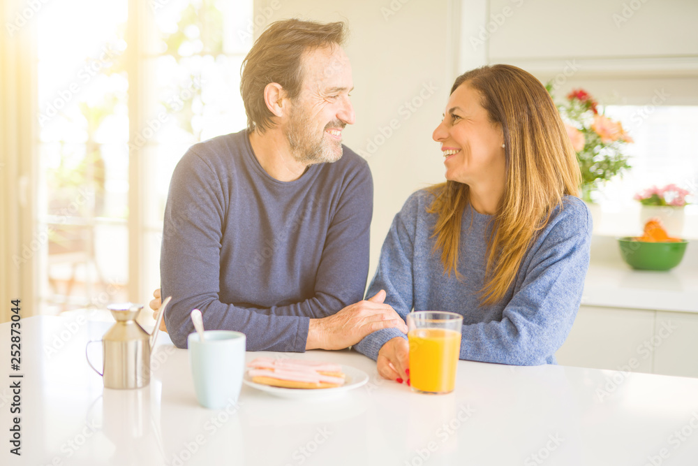 Beautiful romantic middle age couple having healthy breaskfast in the morning at home