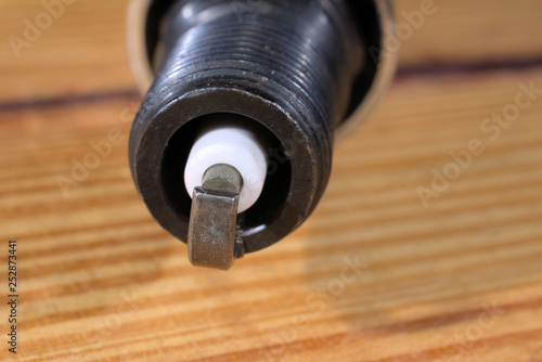 Close up of spark plug on wood