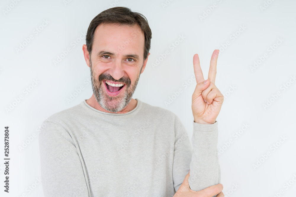 Elegant senior man over isolated background smiling with happy face winking at the camera doing victory sign. Number two. Elegant senior man over isolated background smiling with happy face winking at the camera doing victory sign. Number two.