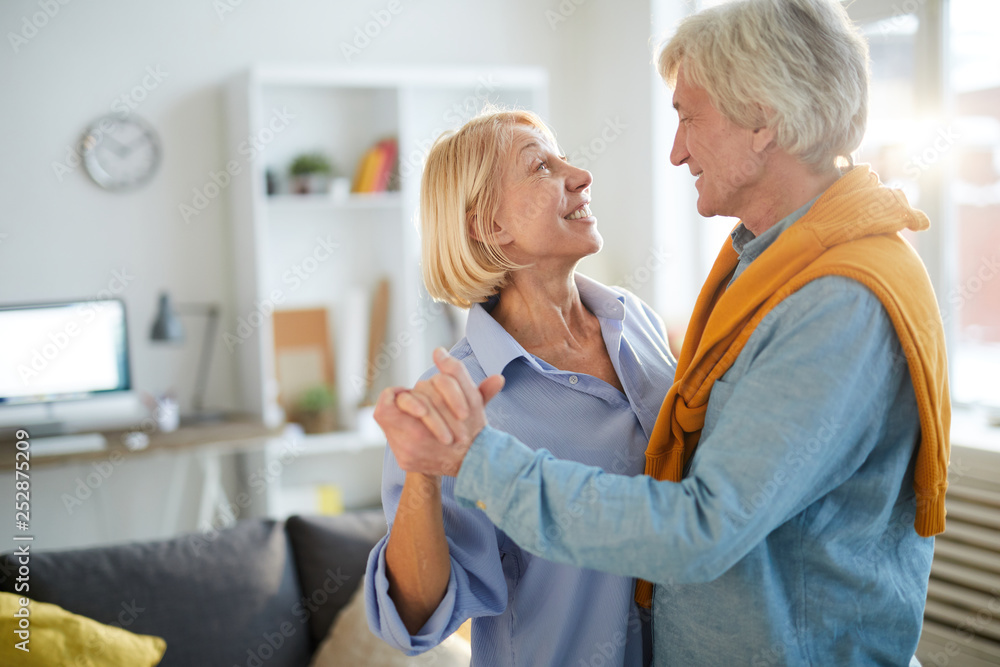 Side view portrait of loving senior couple dancing at home, copy space Side view portrait of loving senior couple dancing at home, copy space