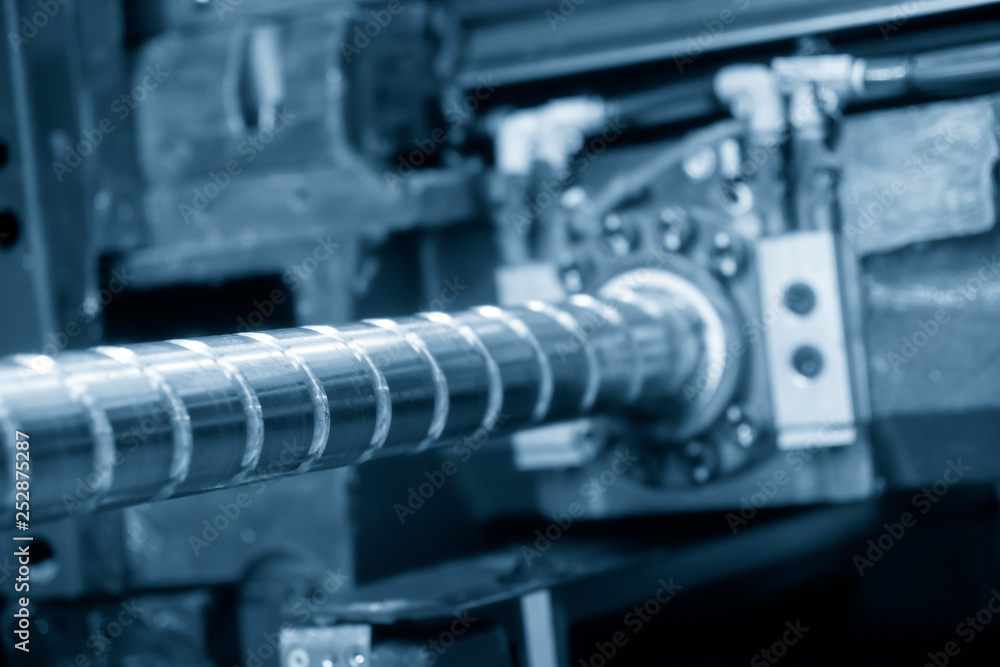 Closeup the lead screw of the CNC machine in the light blue scene.The hi-precision part manufacturing of CNC machine Closeup the lead screw of the CNC machine in the light blue scene.The hi-precision part manufacturing of CNC machine
