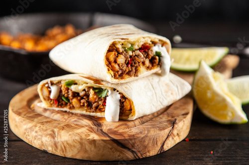 Mexican burrito with beef, beans and sour cream