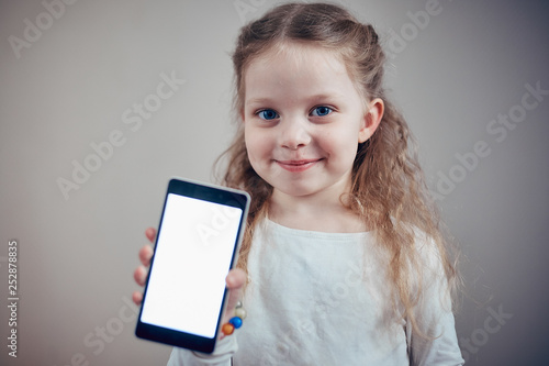 little girl holding a smartphone with a white screen