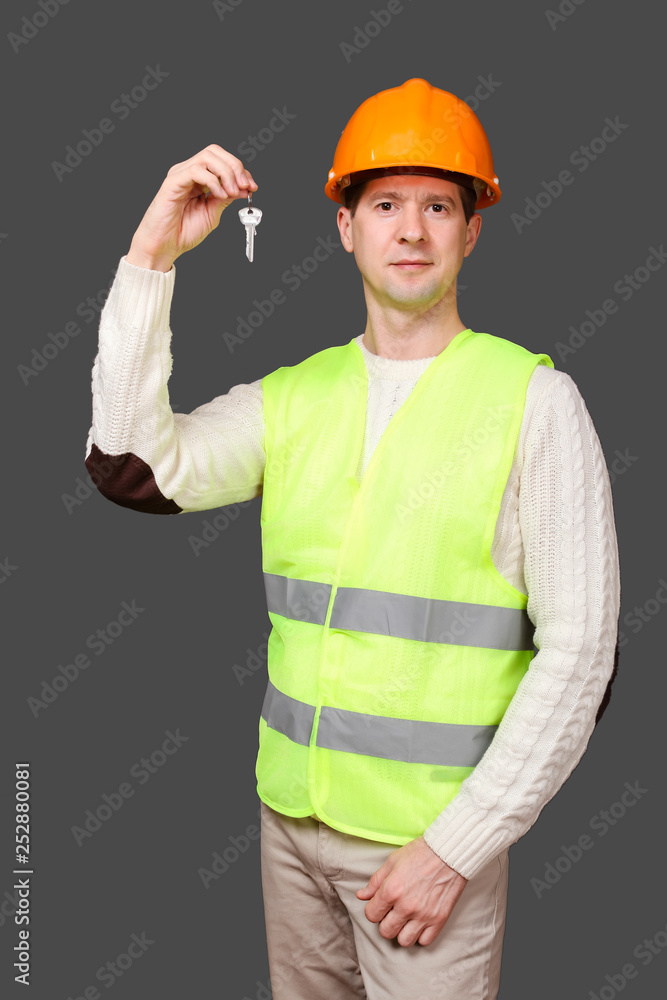 The designer keeps keys in fingers of hands in a helmet The designer keeps keys in fingers of hands in a helmet