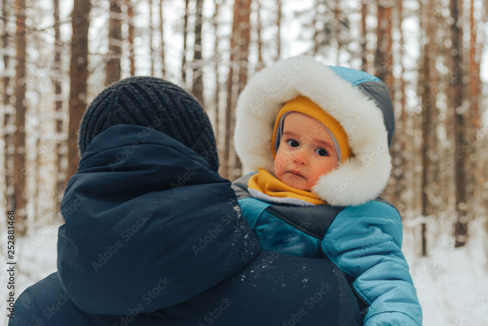 Dad with his son walks in the winter in the woods. Family walks in nature in winter. Winter forest. Snow park. Dad with his son walks in the winter in the woods. Family walks in nature in winter. Winter forest. Snow park.