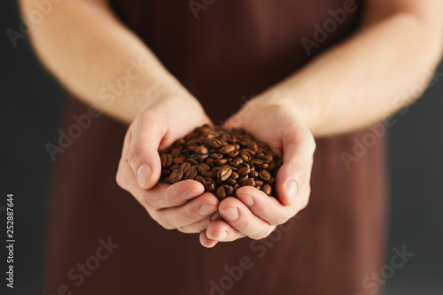 A man with a handful of coffee beans in his hands