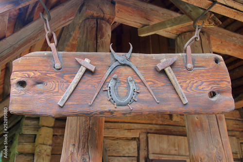 Blacksmith tools attached to a wooden board.