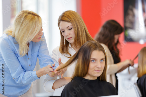 teacher helping student hairdressers