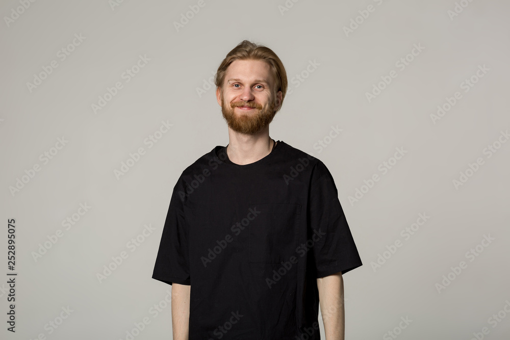 Smiling young man with beard in black shirt Smiling young man with beard in black shirt