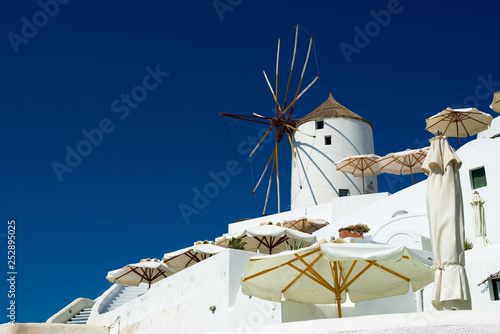 Old windmill in Oia on a sunny day, Santorini, Greece.