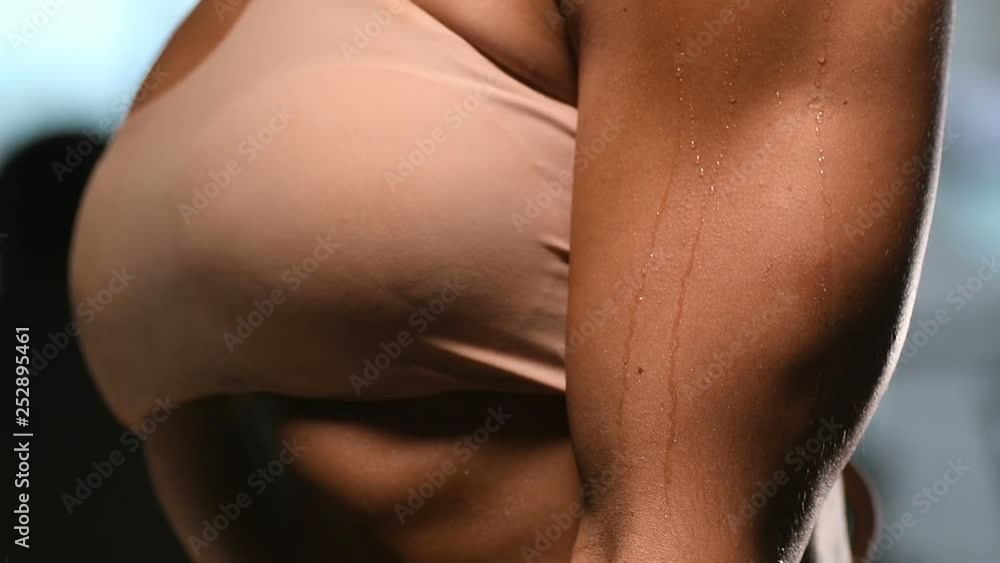 pretty caucasian fitness woman pumping up muscles biceps and triceps workout fitness and bodybuilding concept gym background arms exercises in gym naked torso pretty caucasian fitness woman pumping up muscles biceps and triceps workout fitness and bodybuilding concept gym background arms exercises in gym naked torso