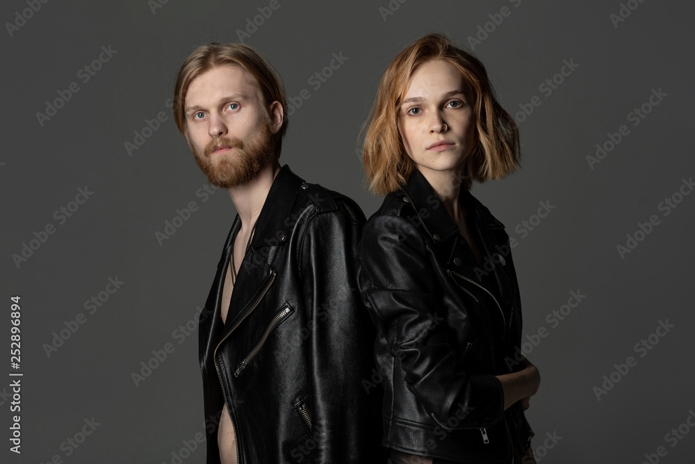 Beautiful young couple with long hair in black leather jackets Beautiful young couple with long hair in black leather jackets