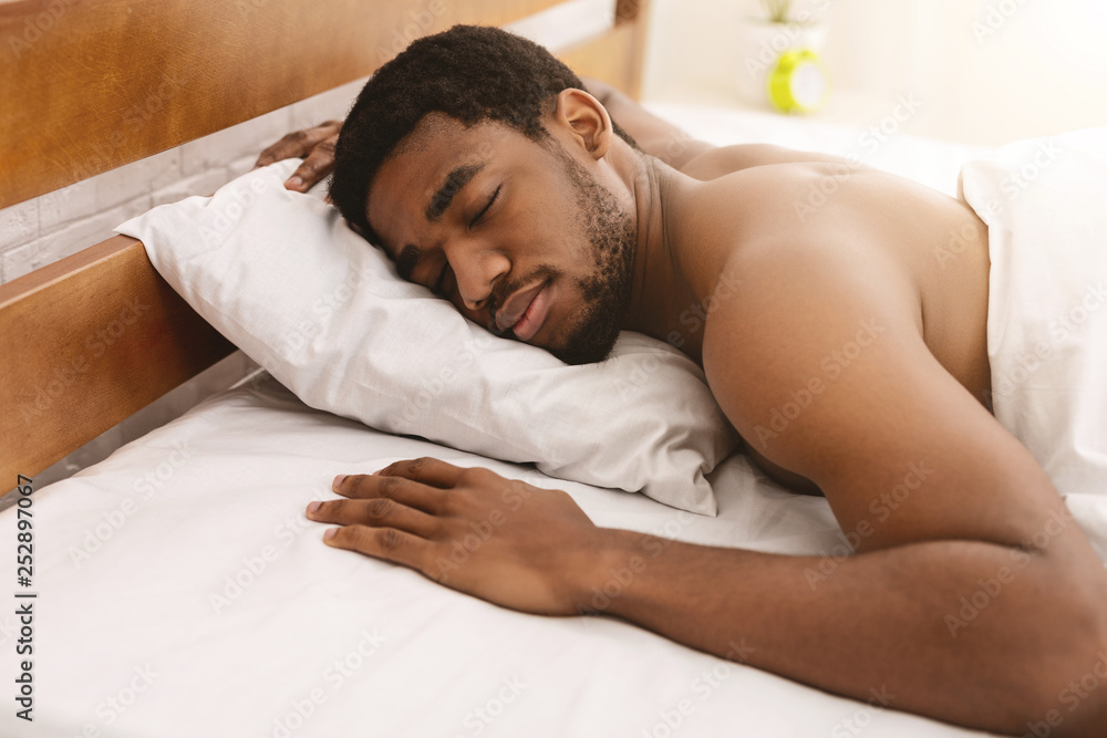Naked african-american man sleeping in bed closeup Stock Photo | Adobe Stock