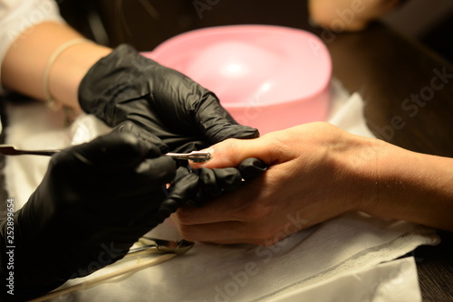 manicure in the salon. Coating gel varnish photography close-up.