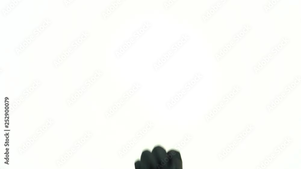 The movement of a man's hand in a black rubber glove for tattoos. Hand shows ok, cool. The movement of a man's hand in a black rubber glove for tattoos. Hand shows ok, cool.