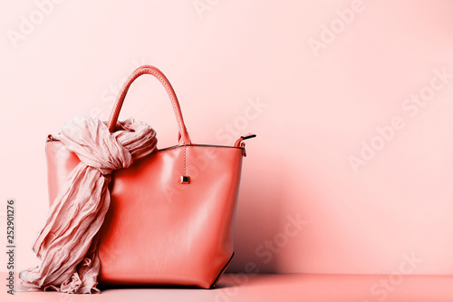 Female handbag with scarf on living coral background photo