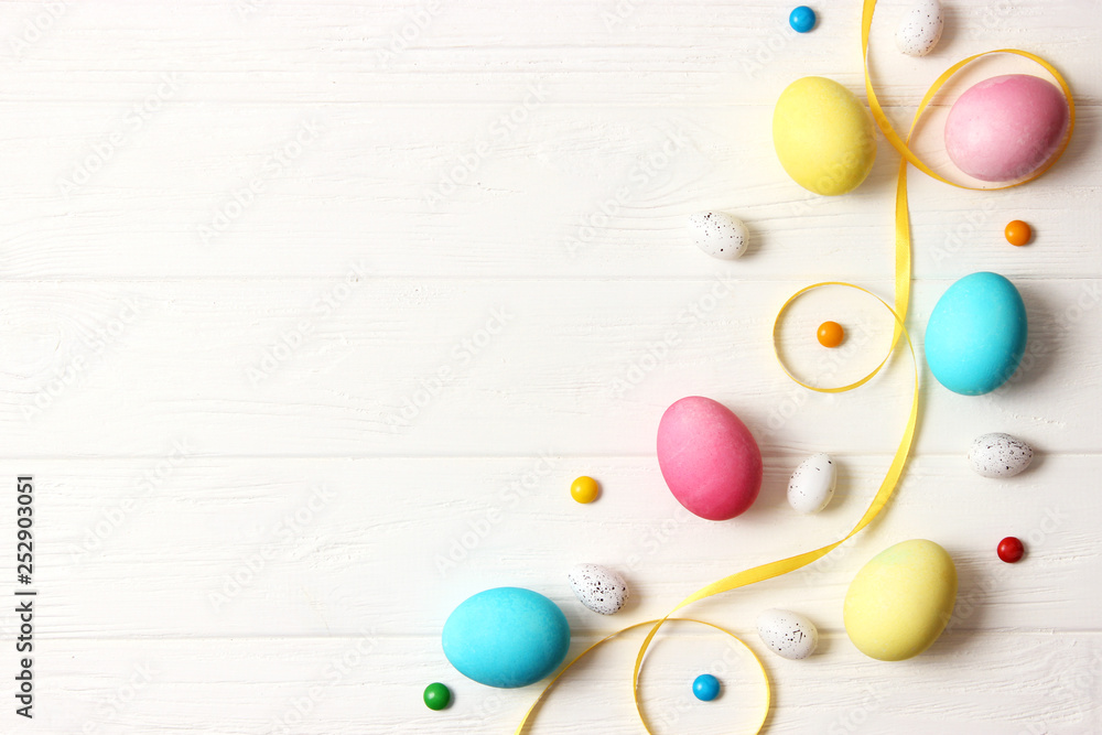 Easter composition of painted eggs and feathers on wooden background. Background for Easter, a place to insert text Easter composition of painted eggs and feathers on wooden background. Background for Easter, a place to insert text