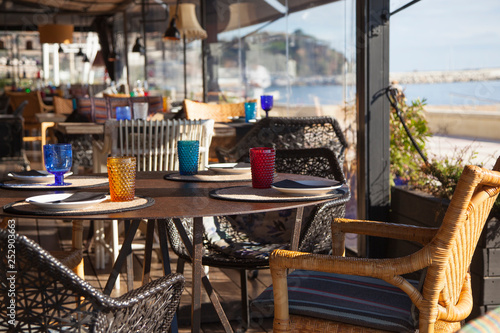 Colorful and sunny restaurant terrasse with seascape as a background
