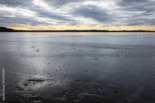 Ice on a frozen lake at sun...