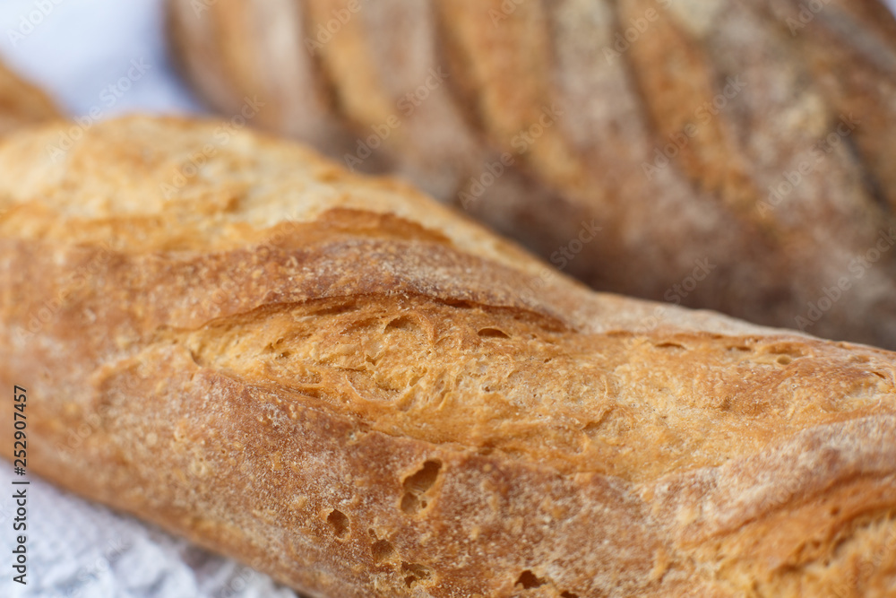 Closeup fresh baked bread on light blurred background