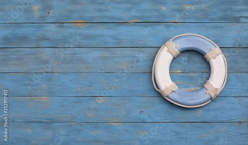 sea wooden lifebuoy on blue wooden background