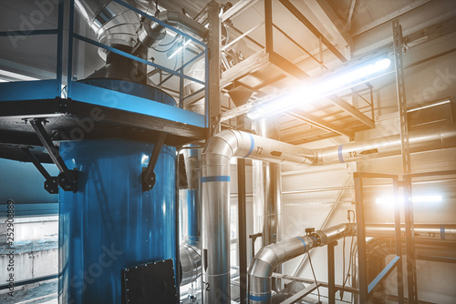 condensing economizer with fuel supply system pipes for solid-state chip boiler. Blue toning with lamps flare