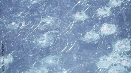 Hail damage on wind shield cracked a n broken from the ice slow motion