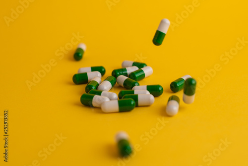 pills in yellow background