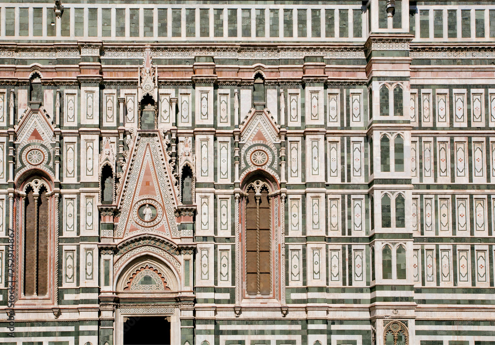 Facade of 14th century Cattedrale di Santa Maria del Fiore, Florence. Reliefs on historical walls of italian cathedral, UNESCO World Heritage Site