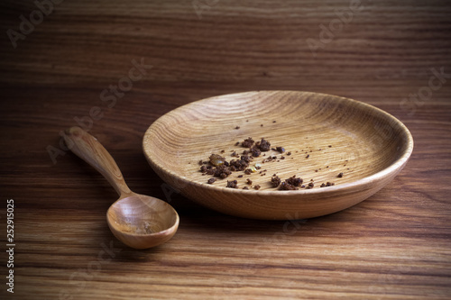 Fasting, Lent. Plate with spoon and crumb on wooden background