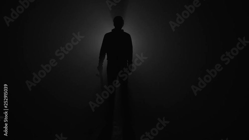 Silhouette of male skateboarder with skateboard in slow motion