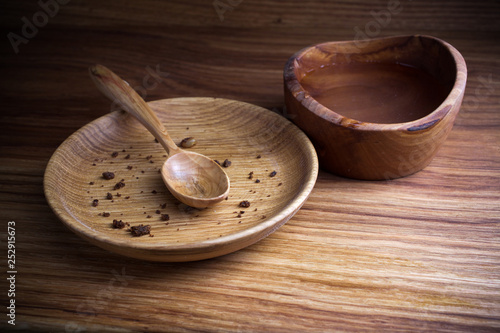 Fasting, Lent. Plate with spoon and cup of water on wooden background