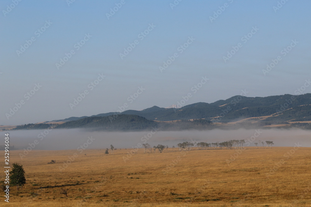 Fototapeta premium Misty plains Rocky Mountains