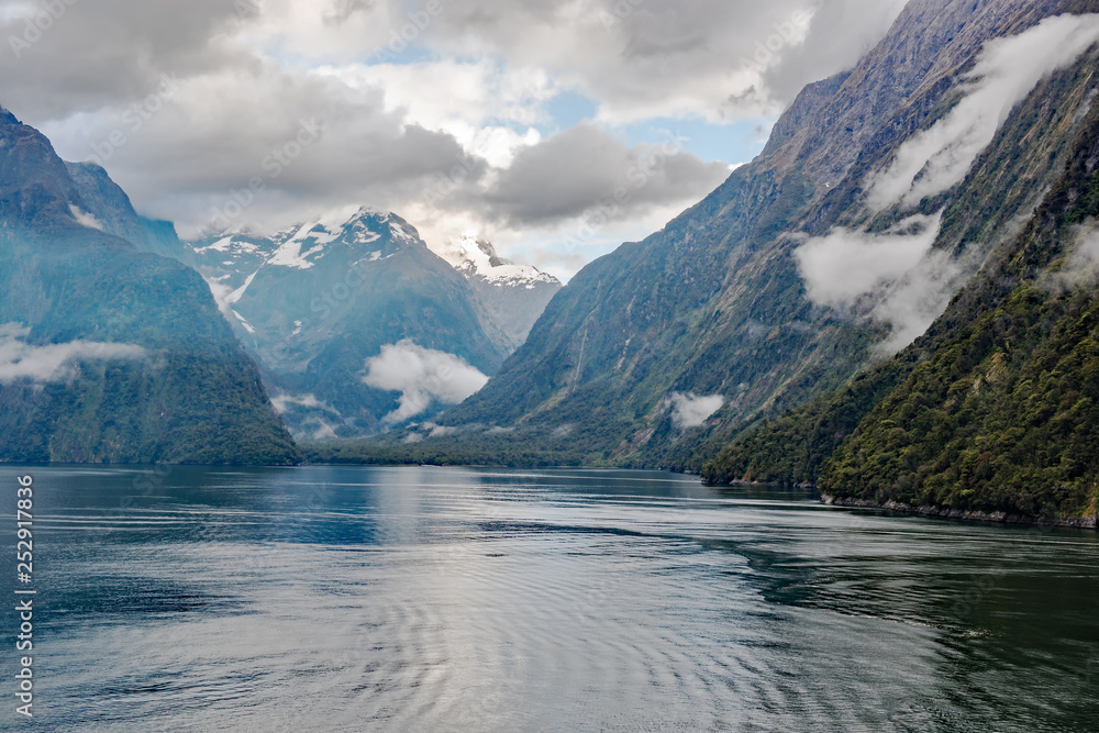 Morning passage through the iconic Milford Sound in Fiordland National Park, South Island, New Zealand