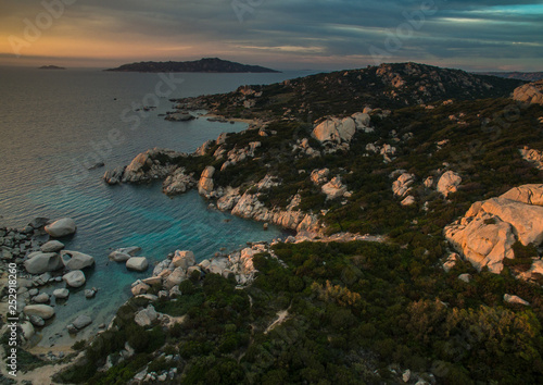 Scenic Sardinia island landscape. Italy sea ​​coast with azure clear water. Nature background. Aerial image with warm evening light.