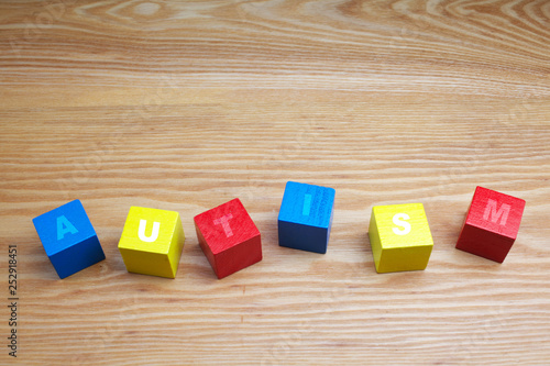 concept of autism word on colored wooden cubes