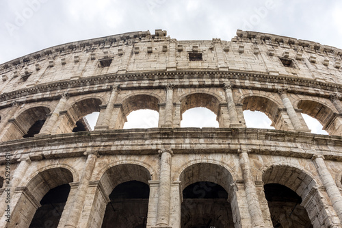 Facade of the Great Roman Colosseum  Coliseum  Colosseo   also known as the Flavian Amphitheatre. Famous world landmark. Scenic urban landscape.