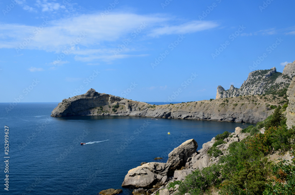 Cape Kapchik in the Black Sea near the village of Novy Svet sunny summer day. Mountain in the form of a dolphin, side view