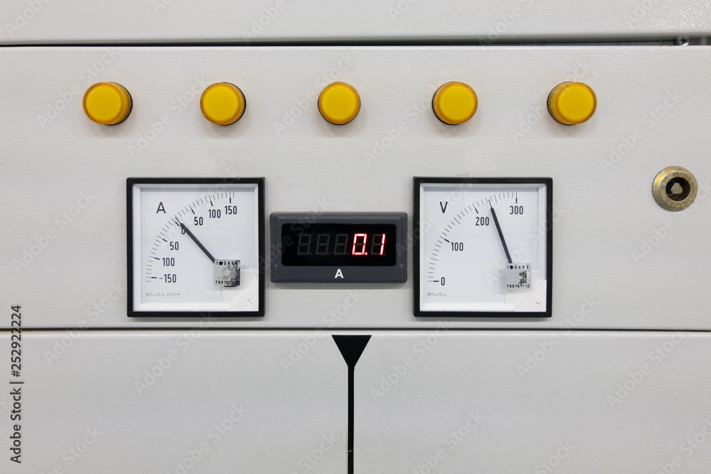 Fragment of electric cabinet with measurement devices showing voltage and current Fragment of electric cabinet with measurement devices showing voltage and current