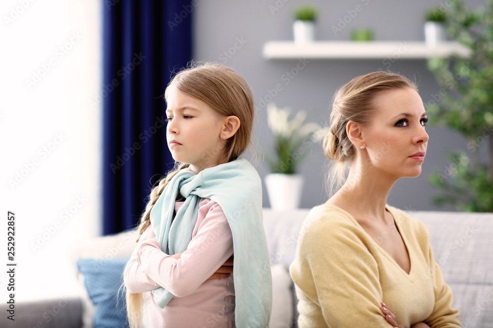 Mother and little daughter having argument at home