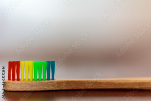Ecological bamboo toothbrush on wooden table © raquel