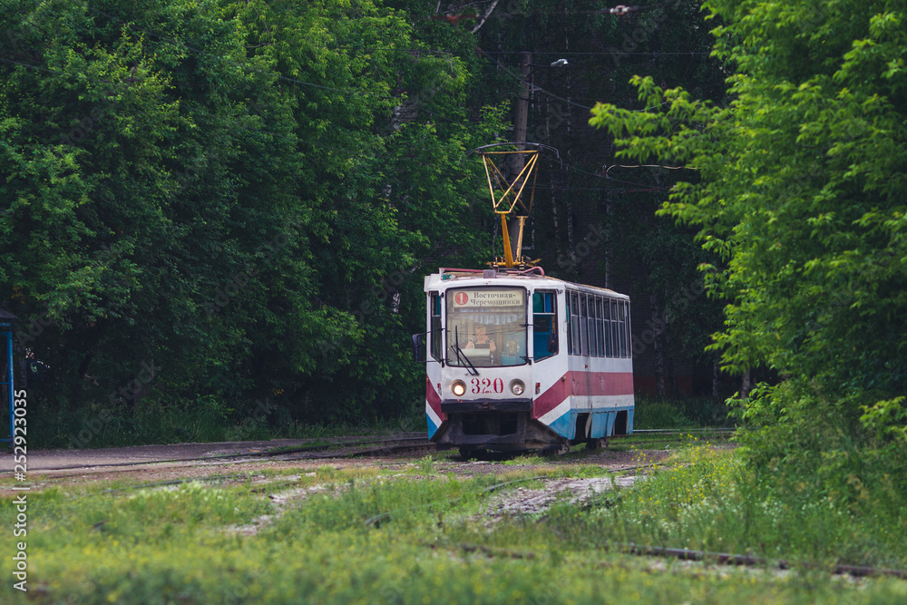 Tomsk, Siberia / Russia – JUL 2, 2018: old tram KTM-5M3 (71-605) No. 320 with a sign route 1 on Lebedeva street