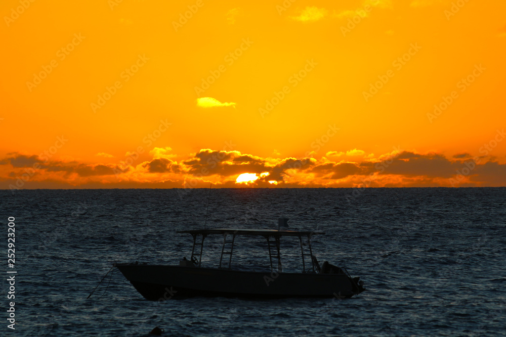 Lights of sunset with a boat on Octopus Beach, Waya Island, Yasawa, Fiji