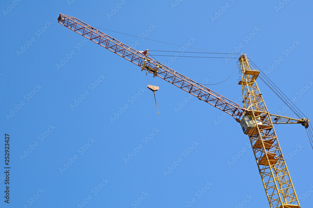 Construction crane on blue sky background Construction crane on blue sky background